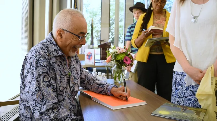 Poet Juan Felipe Herrera signs copies of his books at the awards ceremony in the SC State Library. 