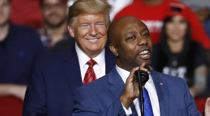 FILE - Sen. Tim Scott, R-S.C., speaks in front of President Donald Trump during a campaign rally, Feb. 28, 2020, in North Charleston, S.C. Scott is expected to endorse former President Trump ahead of the New Hampshire GOP primary taking place on Tuesday, Jan. 23, 2024. A person familiar with Scott's plans confirmed Friday, Jan. 19, to The Associated Press that Scott would travel from Florida to New Hampshire with Trump, the GOP front runner. (AP Photo/Patrick Semansky, File)