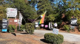  Anti-abortion demonstrators stand among flags and signs hung by those who protest for greater abortion and reproductive healthcare at the Greenville Women's Clinic. It's one of only three places in South Carolina where abortions are performed.