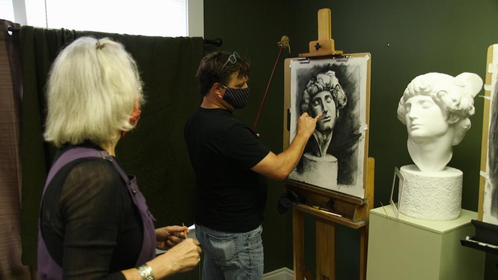 Nancy Thomas Wofford offers her artistic opinion to Jimmy O'Neal as he works on a cast drawing of Michelangelo.