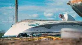 A Local Fisherman Works to Restore Damaged Boats: asset-mezzanine-16x9