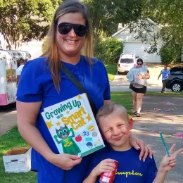 photo of mother and child holding Smart Cat stickers at an event