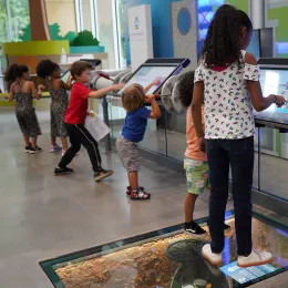 photo of students engaging with an exhibit at Roper Mountain
