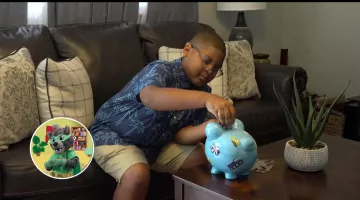 Little boy with piggy bank