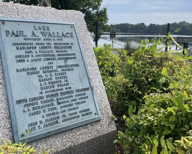 After a dam breach, state officials have spent months trying to keep overspill from happening at Lake paul A. Wallace. But spills still plague two poor, low-lying neighborhoods on one end of the lake.