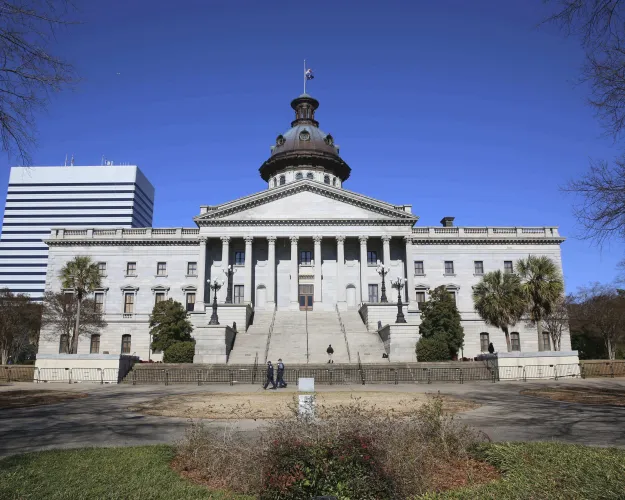 Police officers are the only people seen at the South Carolina Statehouse on Wednesday, Jan. 20, 2021, in Columbia, South Carolina. The capitol was closed for safety concerns for President Joe Biden's inauguration. (AP Photo/Jeffrey Collins)