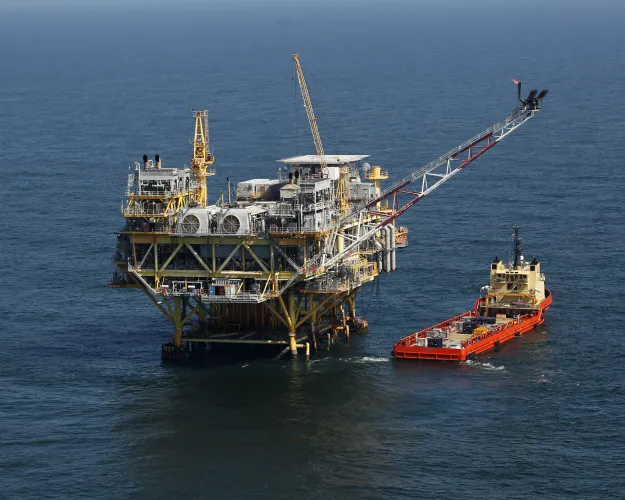 FILE - This April 10, 2011, file photo, shows a rig and supply vessel in the Gulf of Mexico, off the coast of Louisiana. The Biden administration on Friday proposed up to three oil and gas lease sales in the Gulf of Mexico over the next five years — and none in Alaska — as it tries to navigate between energy companies that have pressed for greater oil and gas production and environmental activists who have urged President Joe Biden to shut down new offshore drilling in the fight against climate change.