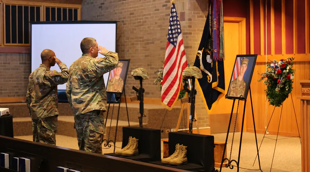 Soldiers participate in final salutes for Privates Timothy Ashcroft and Ethan Shrader during a memorial service