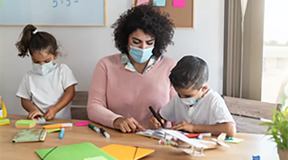 Mother working on project with her children