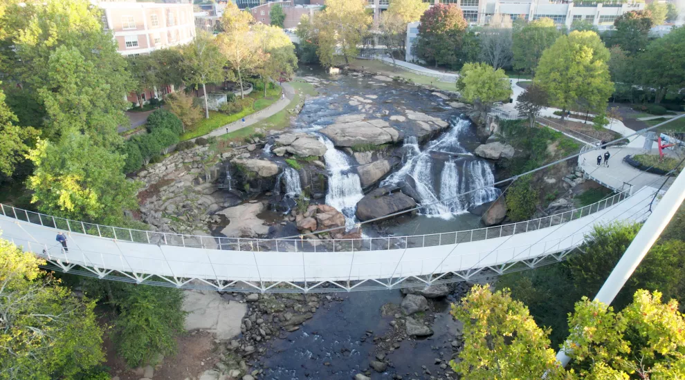 Aerial view of the Liberty Bridge and waterfall in Falls Park, Greenville.