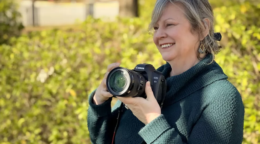 photo of Ginger Cassell holding a camera