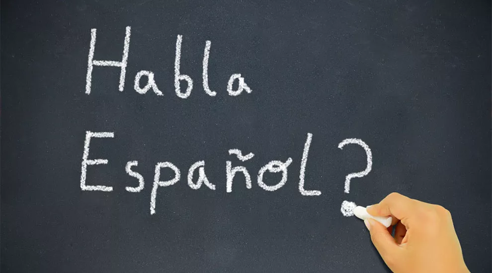 Image of the words "Habla Espanol?" written on a blackboard