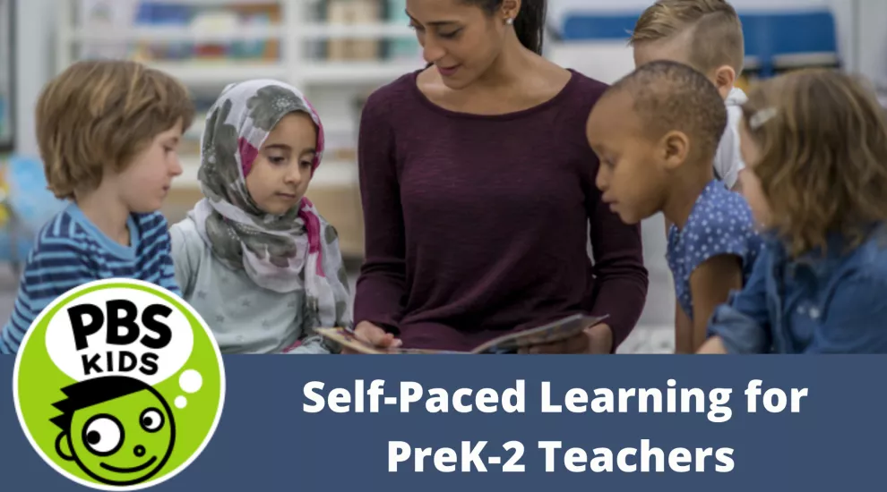 photo of teacher and young students looking at a book together