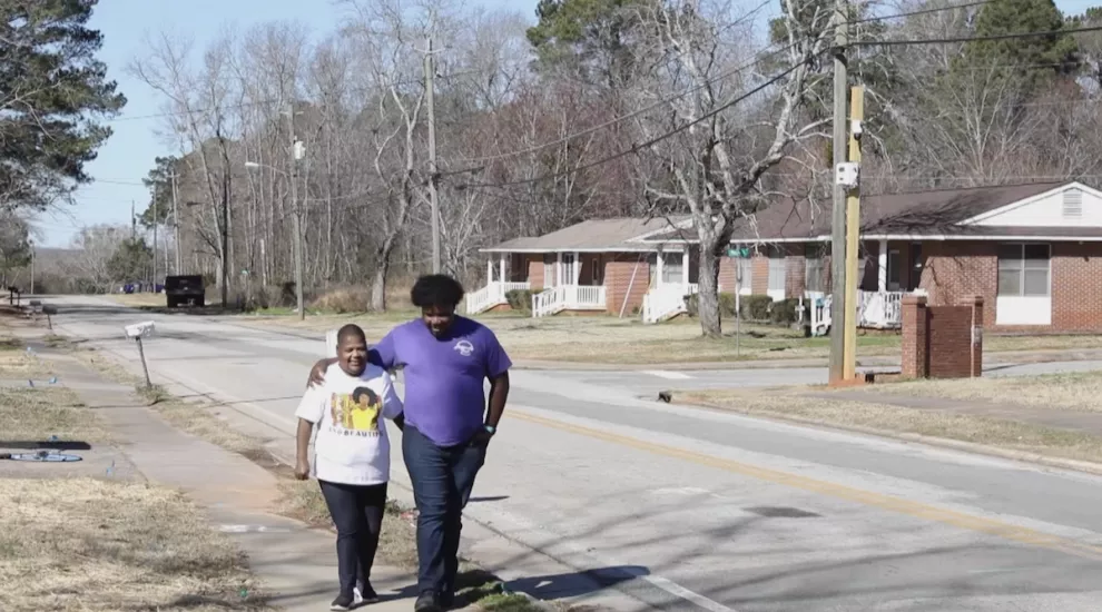 Ms. Leona walking with son