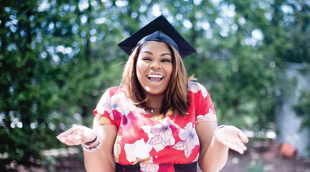 photo of woman wearing a graduation cap 