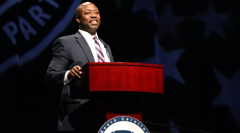 Photograph of Senator Tim Scott speaking from behind a wooden podium.