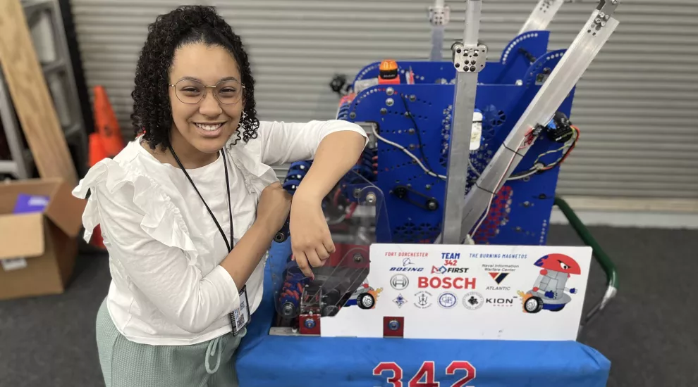 photo of Victoria Zamora standing next to robot project