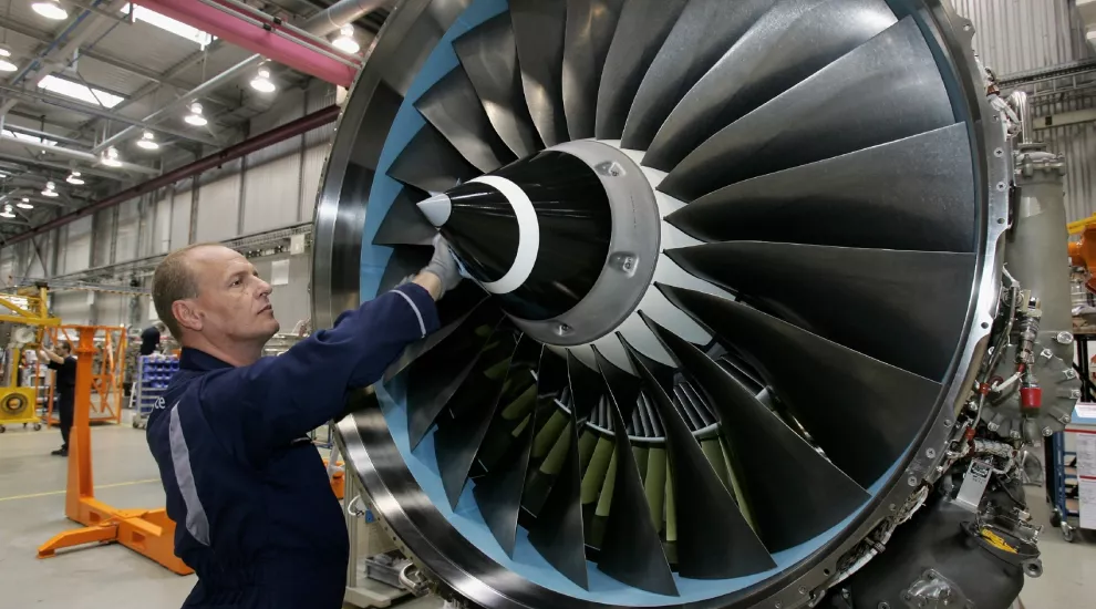 worker cleaning airplane turbine