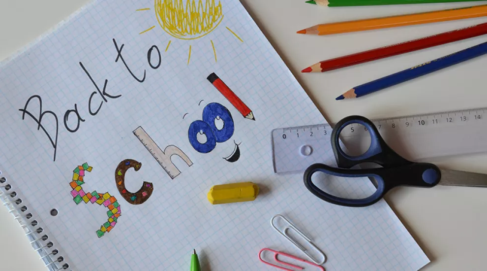 Back to school image with handwritten lettering, pencils, scissors, ruler, etc.