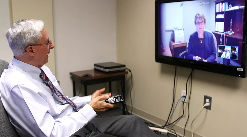 Ed Spencer demonstrates the Telepsychiatry program's high definition technology for video conferencing.