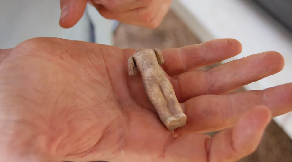 An artifact that was found at the outbuilding site at Fort Hill. It is the body of a small porcelain doll.