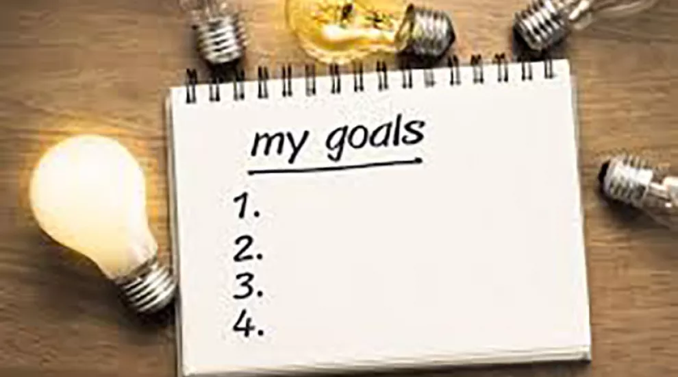 Image of list of goals surrounded by lightbulbs shining