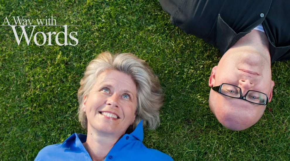 a way with words hosts laying in grass with show title in left upper corner.