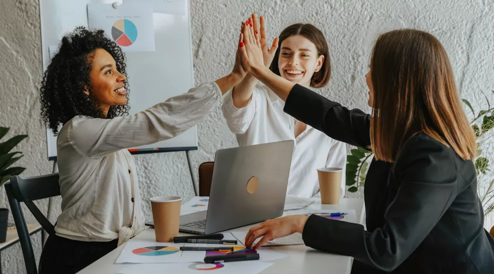 picture of 3 women 'high-fiving' each other