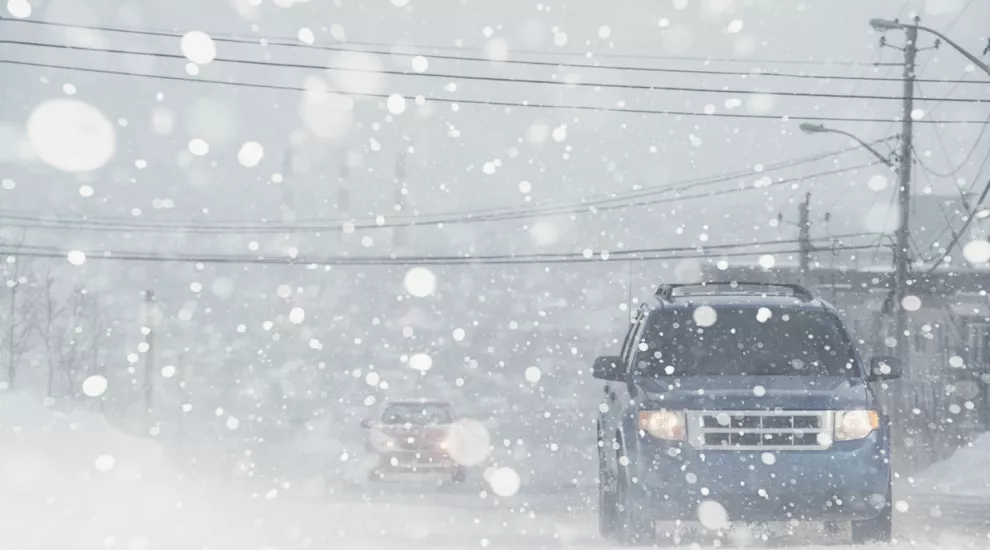 cars driving in winter storm