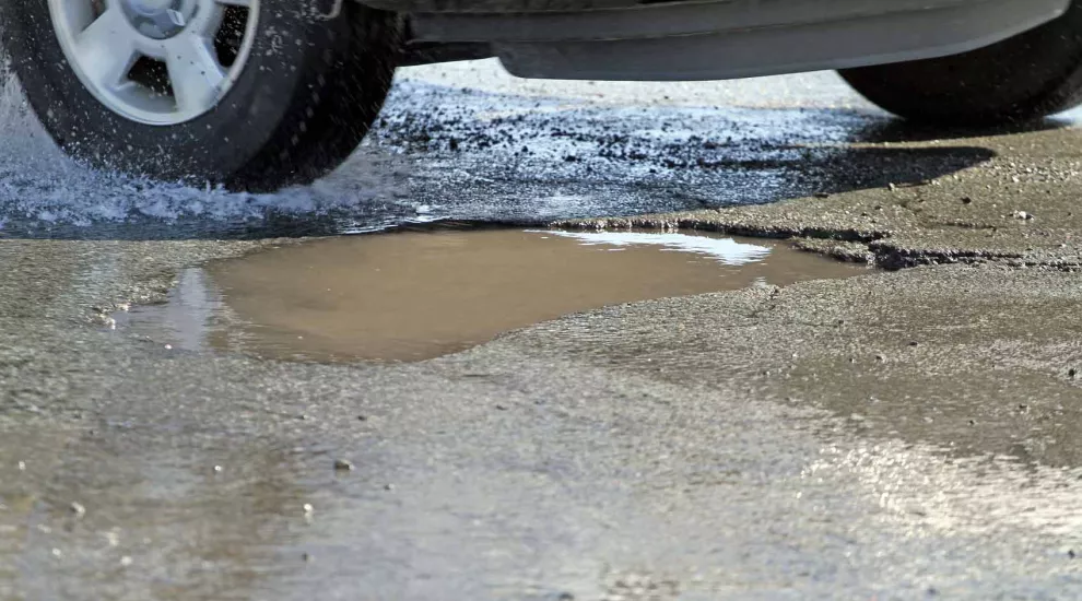 pothole that vehicle is about to hit