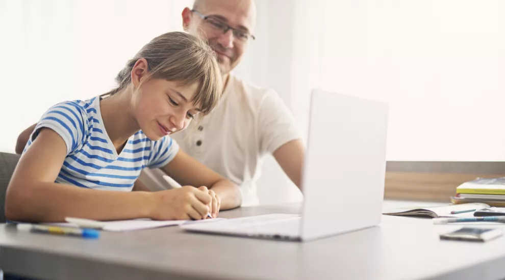 Parent observes child using a laptop