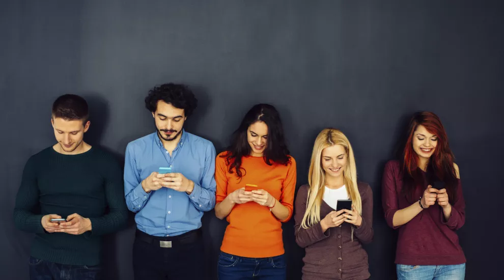 people using phones in a group