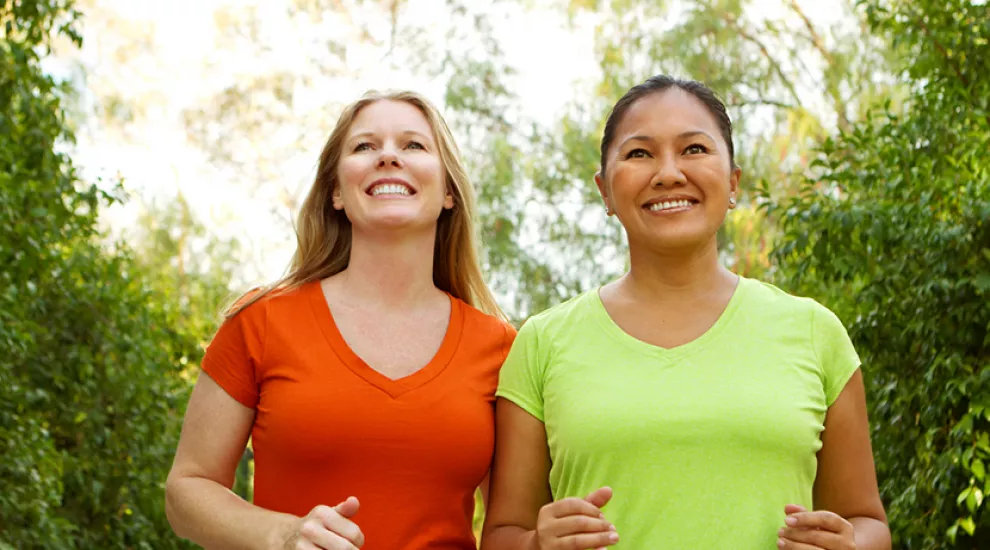 Two women power walking 