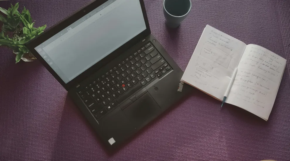 photo of an open laptop and notepad