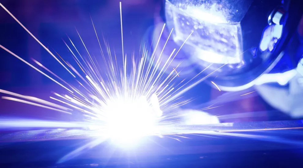 person welding, with great bright sparks