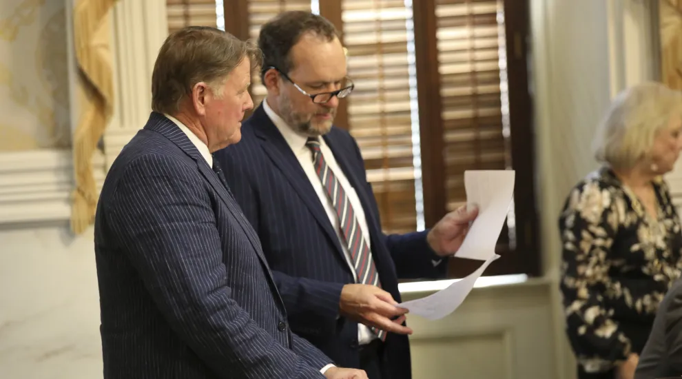 South Carolina Rep. Bill Herbkersman, R-Bluffton, left, talks to House Ways and Means Chairman Bruce Bannister, R-Greenville, right, during a budget debate on Wednesday, May 8, 2024, in Columbia, South Carolina (AP Photo/Jeffrey Collins).