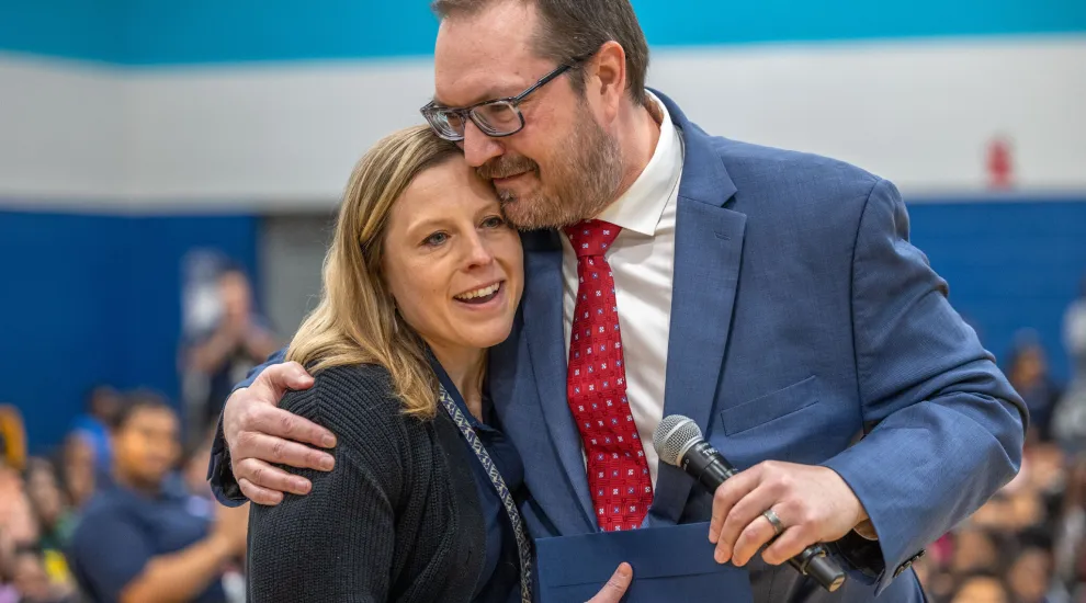 Forest Lake Elementary School interventionist Keighley George is congratulated by National Institute for Excellence in Teaching Chief Executive Officer Dr. Joshua Barnett, on behalf of the Milken Family Foundation.
