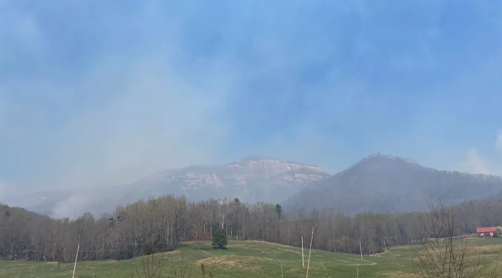 Smoke billowing off Table Rock Mountain is filling the air with a thick smell and a gauzy blanket of airborne particles, a week after igniting. Ten miles away, the fire at Persimmon Ridge is creating further air quality issues.