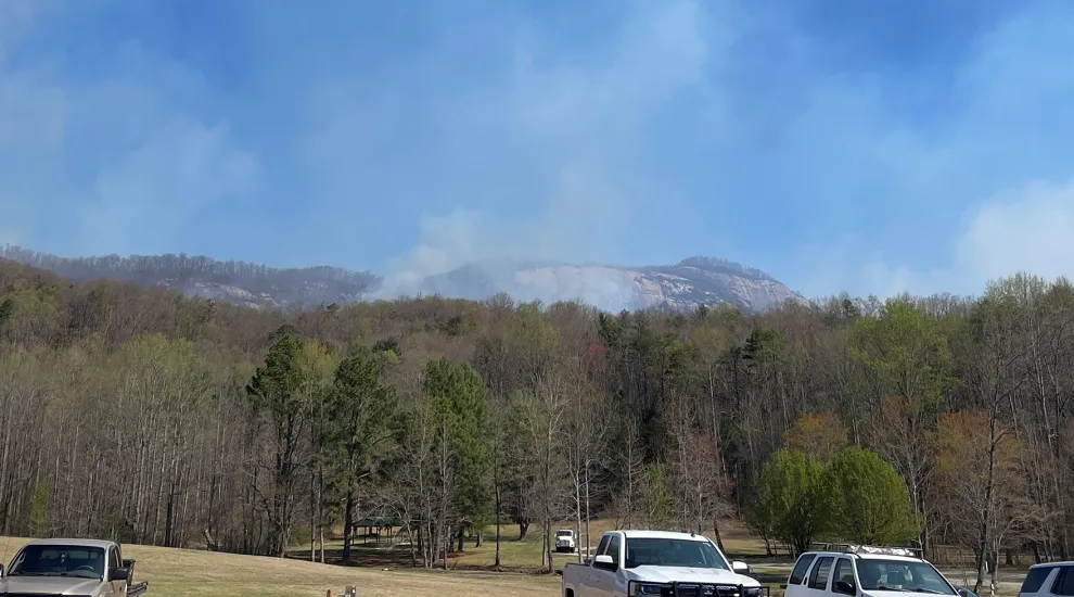 Endless blue skies and dry air gave way Monday to rainclouds over Table Rock Mountain and Persimmon Ridge. Emergency crews have battled ideal conditions for a major fire since Mach 21.