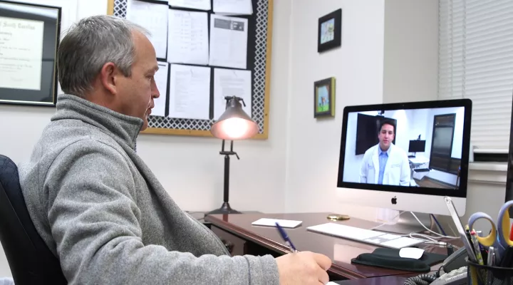 Dr. James Sterrett teleprecepting with a Pharmacy Student. 