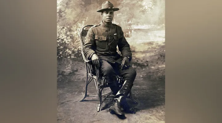 Unidentified African American soldier in uniform with marksmanship qualification badge and campaign hat