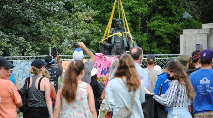 John C. Calhoun statue is set down before a cheering crowd