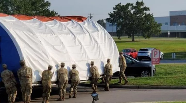Members of the South Carolina National Guard relocate a COVID-19 screening tent 