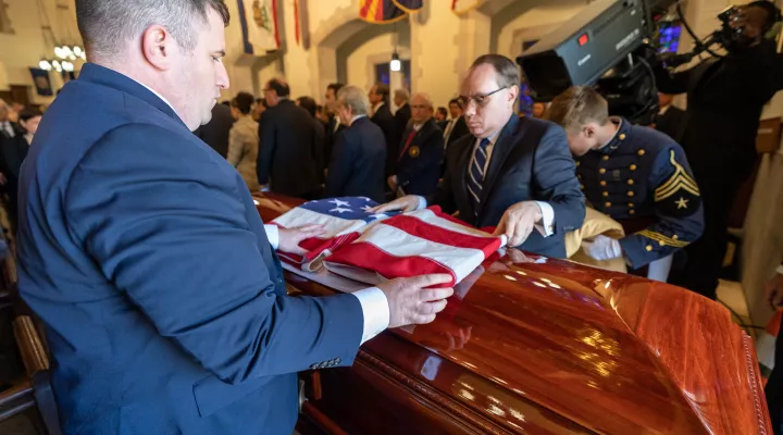 The C The U.S. flag is placed over the casket at the completion of the funeral for former SC Senator Ernest "Fritz" Hollings
