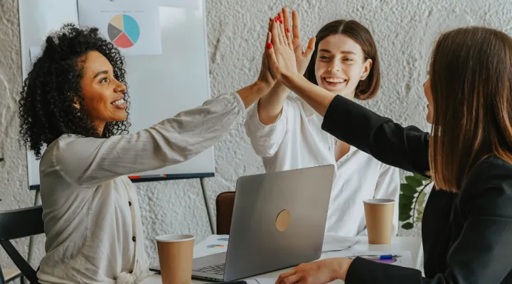 photo of 3 women 'high fiving' each other