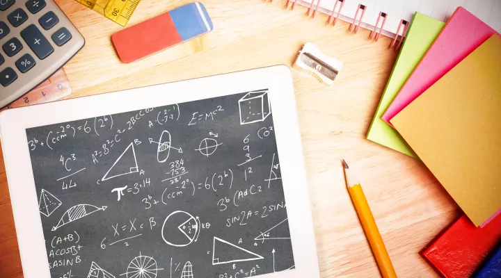 photo of calculator, ruler and tablet showing math calculations