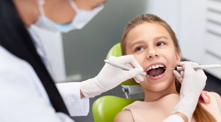 Child looking up at the dentist