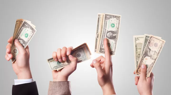 Hands holding up money