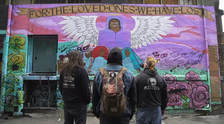 Community members viewing outdoor mural