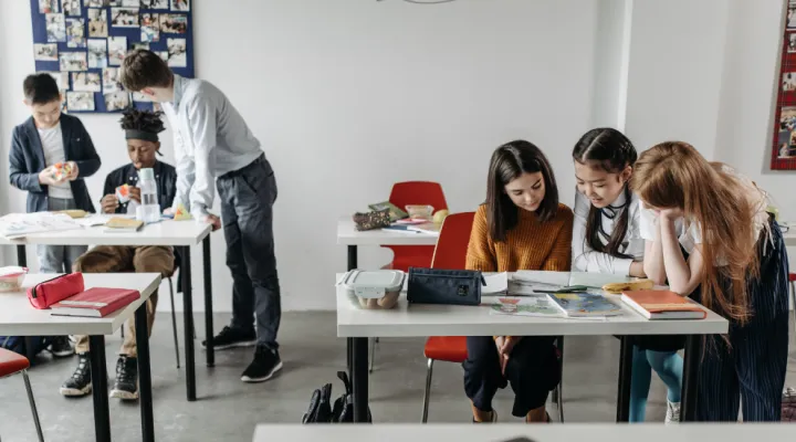 photo of students at a desk in a classroom